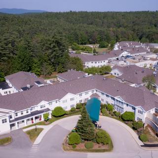 Aerial view of a residential complex surrounded by trees.