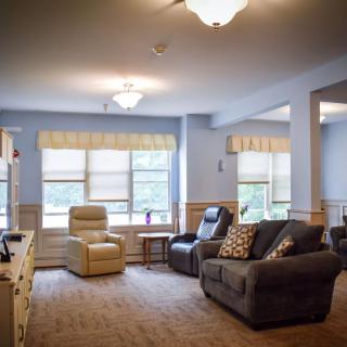 A cozy living room with comfortable seating and large windows.