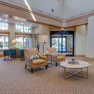 A spacious and elegantly designed lobby with comfortable seating and natural lighting.