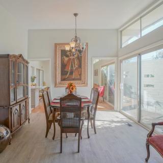 A modern dining room with elegant furniture and ample natural light.