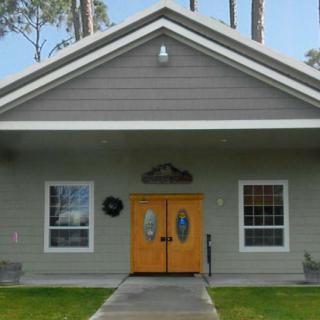 A small house with a double front door and large windows on either side.