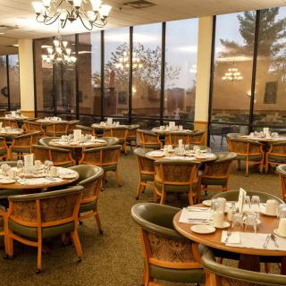 Elegant dining room with neatly arranged tables and large windows.