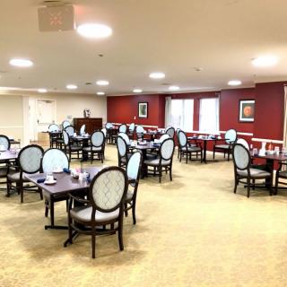 An empty dining area with neatly arranged tables and chairs.