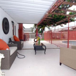 A cozy patio area with comfortable seating overlooking a pool.