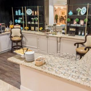 A sophisticated bar area with elegant decor and a counter lined with glasses.