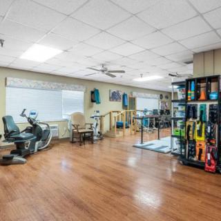 A well-equipped fitness center with a variety of exercise machines and bright interior.