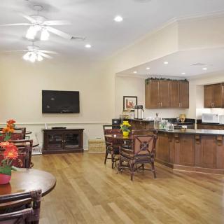 Spacious open-concept living and kitchen area with hardwood floors and modern furnishings.