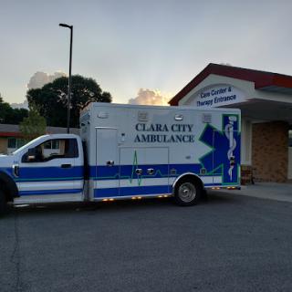 An ambulance parked outside a healthcare facility, ready for emergency response.