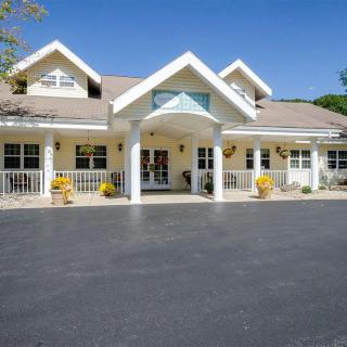 A suburban residential building with a welcoming porch and columns.