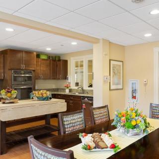 A well-lit kitchen and dining area with modern furnishings and floral decor.