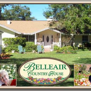 A view of the Belleair Country House surrounded by a well-maintained garden.