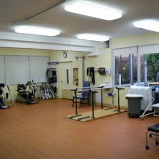 A well-equipped rehabilitation room with exercise machines and therapy stations.