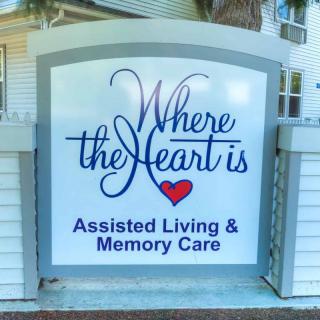 A sign for 'Where the Heart is' Assisted Living & Memory Care facility.