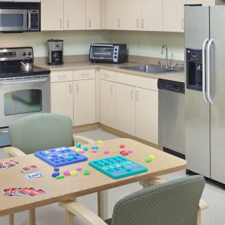 A modern kitchen with a table set up for board games.
