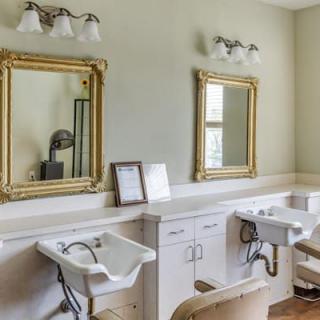 An elegantly designed hair salon setup with mirrors and sink stations.