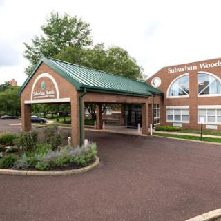 The inviting entrance to a welcoming facility surrounded by landscaped gardens.