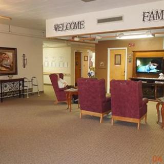 A cozy lobby area with comfortable chairs and a television.