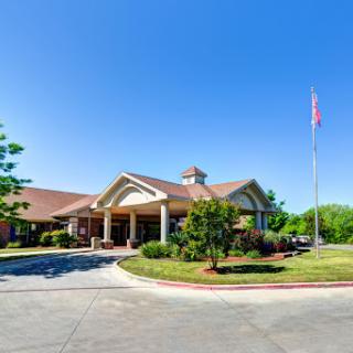 Entrance to a hospitality establishment under a clear blue sky.