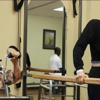 A person using gym equipment for exercise or physical therapy.