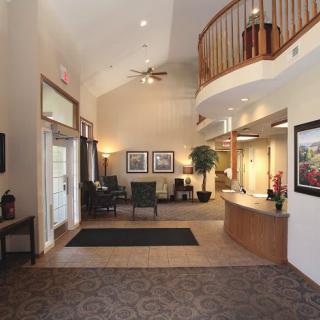 A well-lit lobby with a reception desk and seating area.