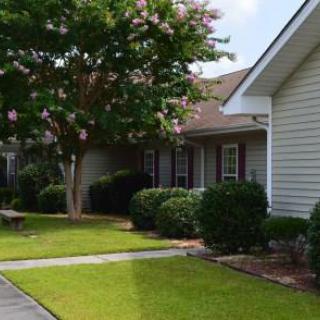 A charming home with a well-maintained front yard and vibrant greenery.