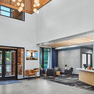 A modern lobby with a reception desk and comfortable seating area.