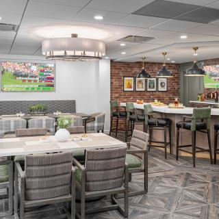A modern restaurant interior with a mix of dining tables, bar seating, and stylish decor.
