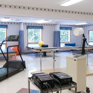 A rehabilitation center equipped with exercise machines and therapy tools.