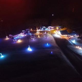 Aerial view of a vibrant holiday light display illuminating the night.