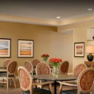 A cozy dining area with elegant decor and floral arrangements.