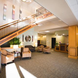 A welcoming lobby with a staircase, comfortable seating, and modern decor.