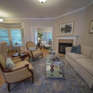 A cozy living room featuring elegant furniture and a fireplace.