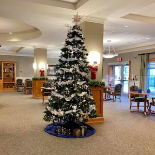 A beautifully decorated Christmas tree in the lobby, surrounded by festive decorations.