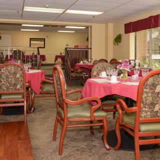 A well-decorated dining area with tables and chairs set for a meal.