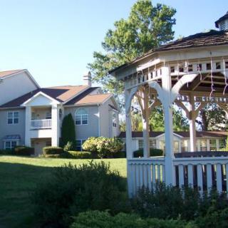 A scenic residential area featuring a gazebo and well-maintained lawns.