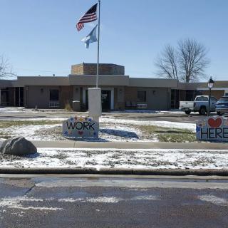 A building with American flags flying in a snowy landscape.