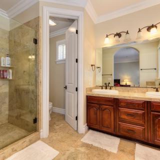 Elegant bathroom featuring a glass-enclosed shower and double vanity sinks.
