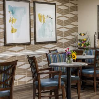 A modern dining area with elegant furnishings and artistic wall decor.