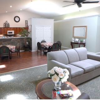 A spacious living room with a sofa, dining table, and modern decor in an open-plan layout.