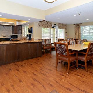 A spacious open-concept kitchen and dining area with hardwood floors and modern furnishings.