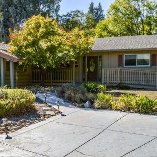 A well-maintained suburban home with a landscaped front yard and driveway.