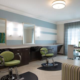 A modern hair salon featuring stylish barber chairs and an inviting interior.