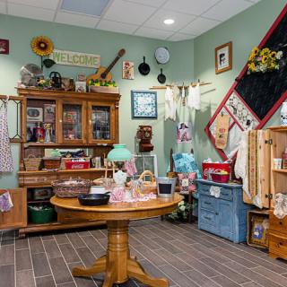 A cozy, vintage-themed kitchen with rustic furniture and antique decor.