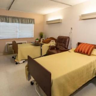 A hospital room with a patient bed and medical equipment.