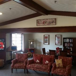 A cozy living room with sofas, a coffee table, and a bookshelf against the wall.