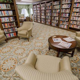 A cozy library reading area with comfortable chairs and bookshelves.