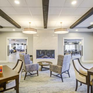 A modern and cozy living room with a central fireplace and comfortable seating arrangement.