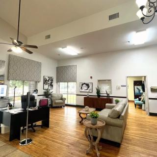 A spacious and modern living room with elegant decor and hardwood flooring.