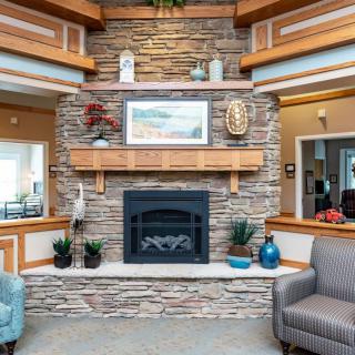 A cozy living room with a stone fireplace and elegant decor.