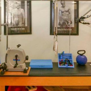 A gym setup featuring various exercise equipment including a kettlebell and a stationary cycle.